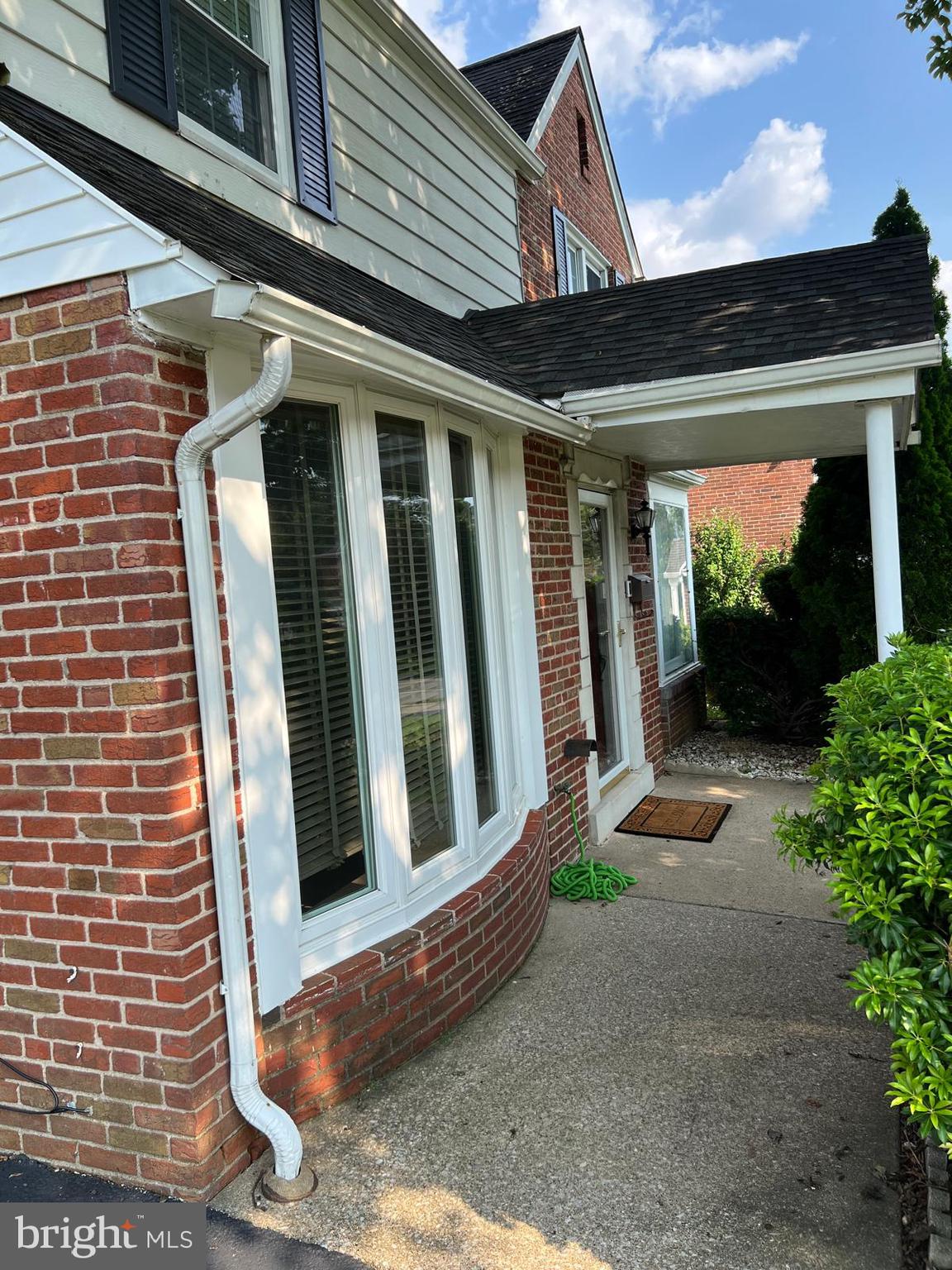 1615 Earlington Road Havertown, PA 19083 - Photo 3 of 72 a view of a brick house with potted plants