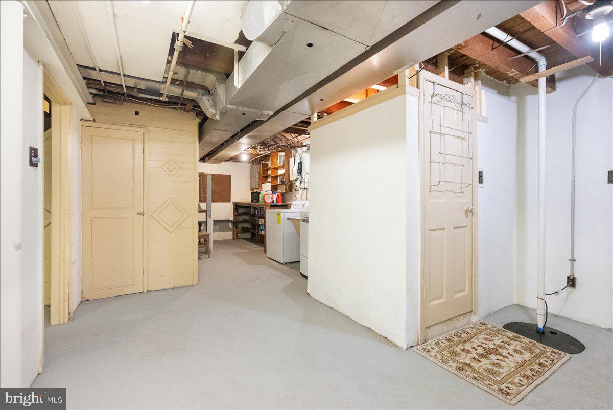 1615 Earlington Road Havertown, PA 19083 - Photo 39 of 72 a view of hallway with stairs and a refrigerator