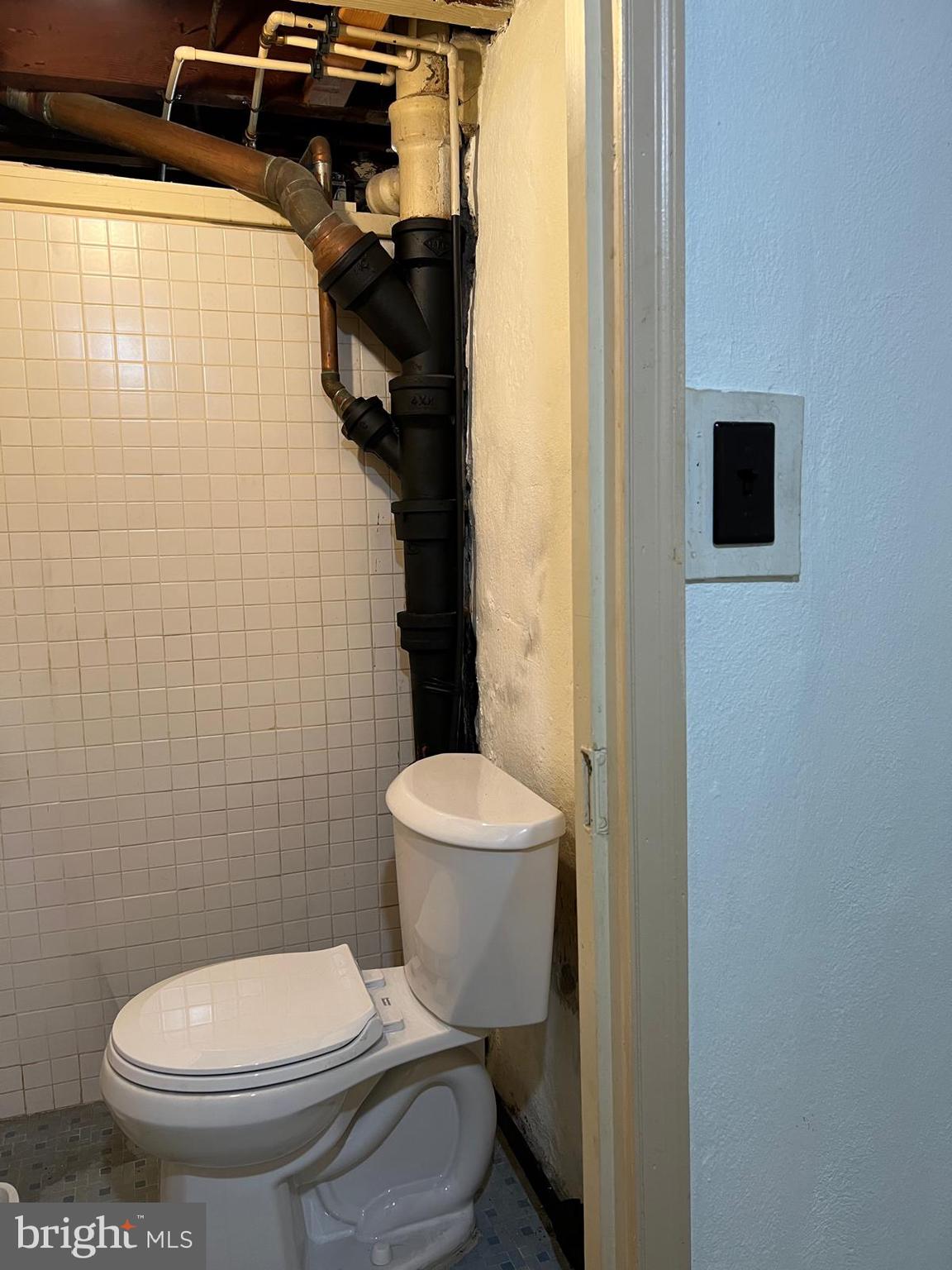 1615 Earlington Road Havertown, PA 19083 - Photo 40 of 72 a bathroom with a toilet and a shower curtain