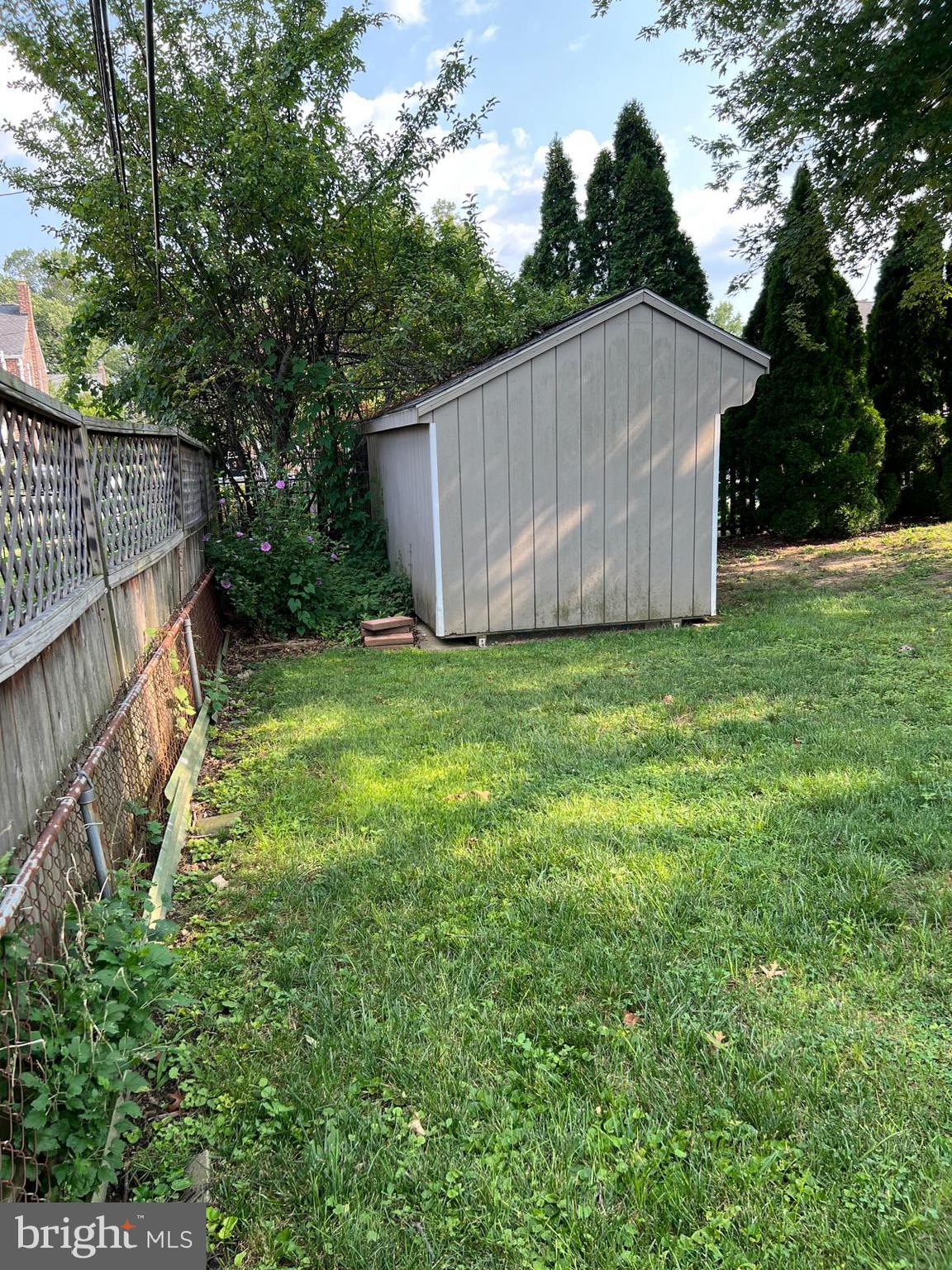 1615 Earlington Road Havertown, PA 19083 - Photo 56 of 72 a view of a backyard with a small cabin and wooden fence