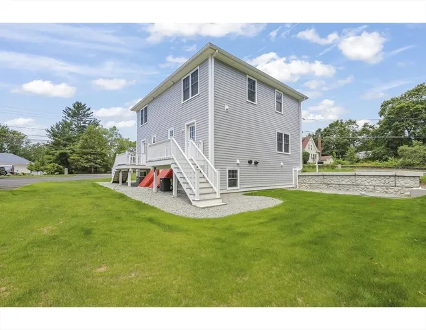 a view of a house with a backyard