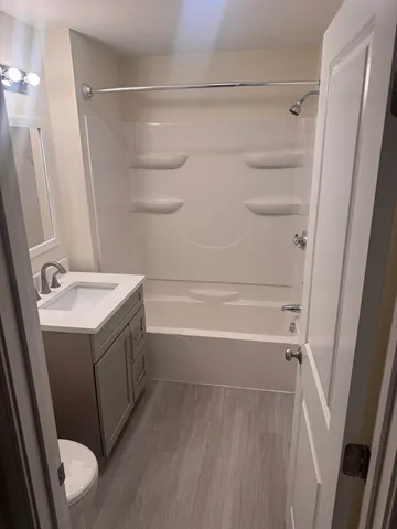 a bathroom with a sink a mirror and a bath tub