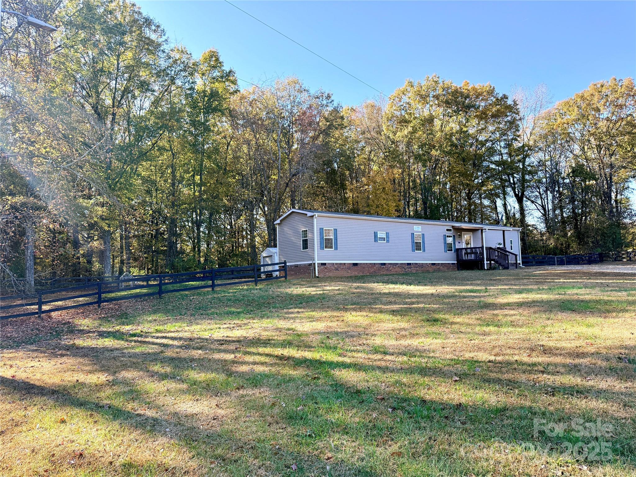 249 Brown Neal Road York, SC 29745 - Photo 2 of 24 a view of a swimming pool with a house in the background