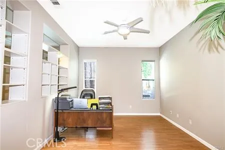 a view of a livingroom with a window and wooden floor