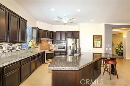 a kitchen with stainless steel appliances granite countertop a stove and a sink
