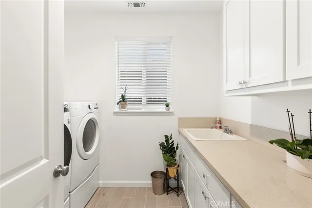 a bathroom with a sink a washer and dryer