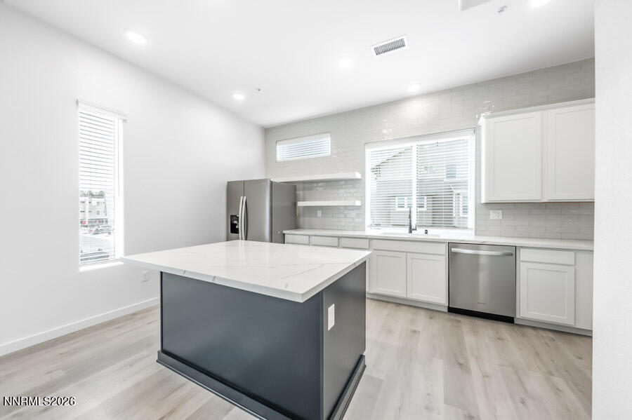 160 Rissone Lane, Unit 32 Reno, NV 89503 - Photo 2 of 5 a kitchen with a sink stove and cabinets