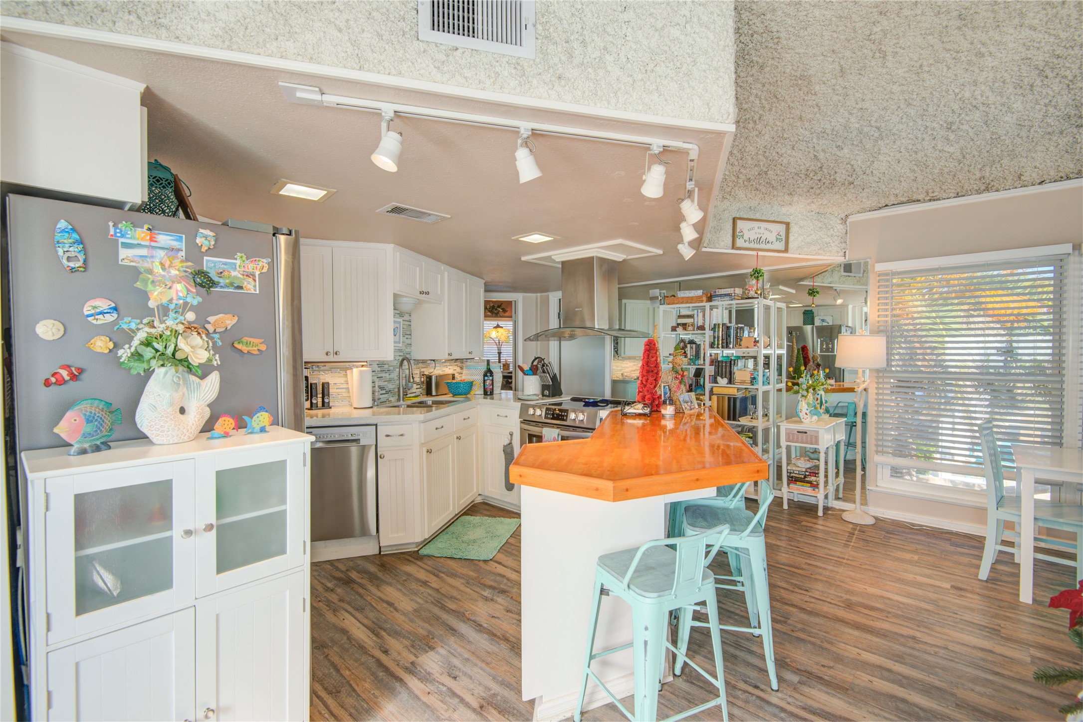 83 Dolphin Lane Freeport, TX 77541 - Photo 12 of 39 a dining room with stainless steel appliances kitchen island granite countertop a table chairs and a stove