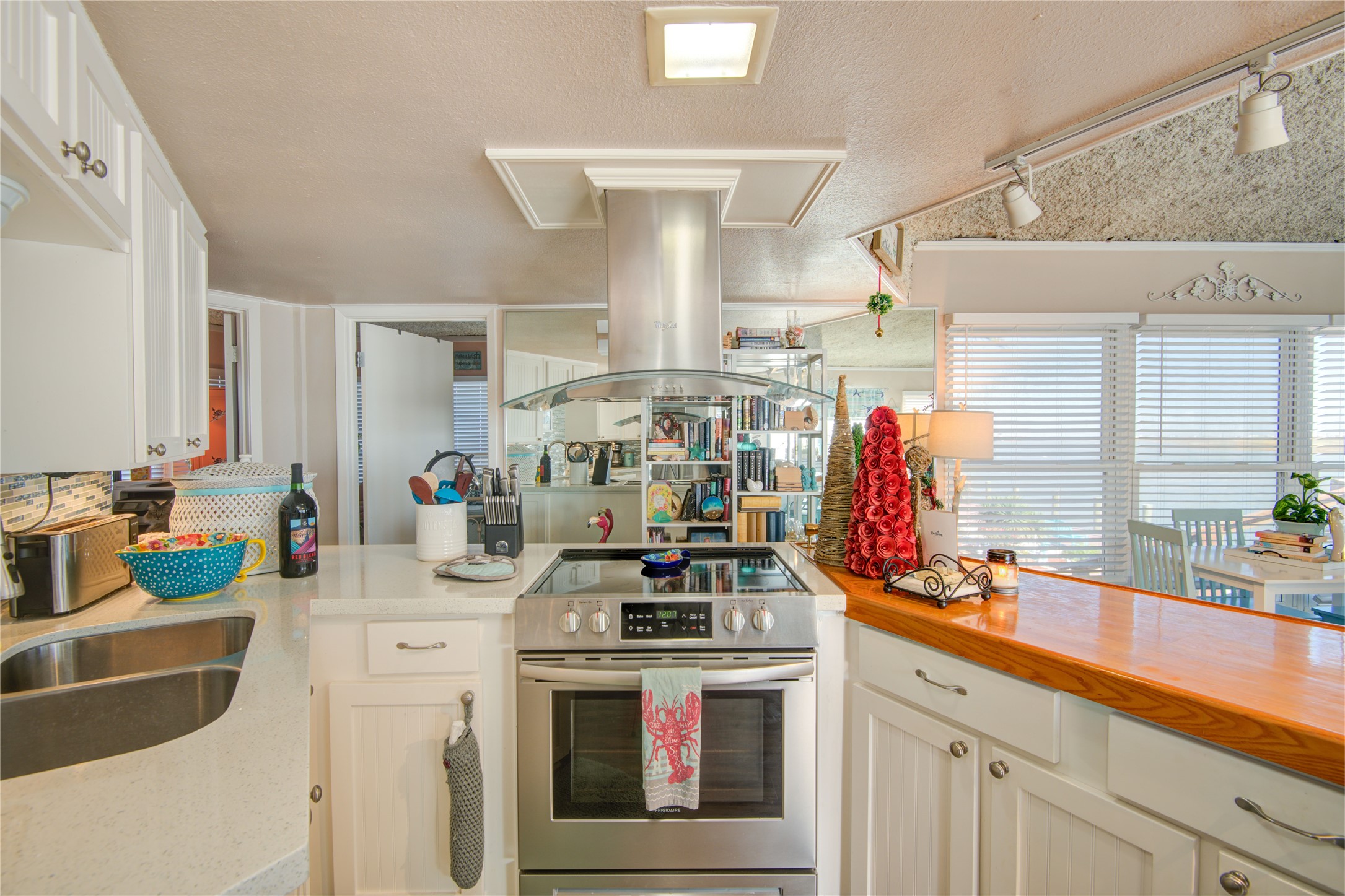 83 Dolphin Lane Freeport, TX 77541 - Photo 13 of 39 a kitchen with stainless steel appliances a sink stove and cabinets