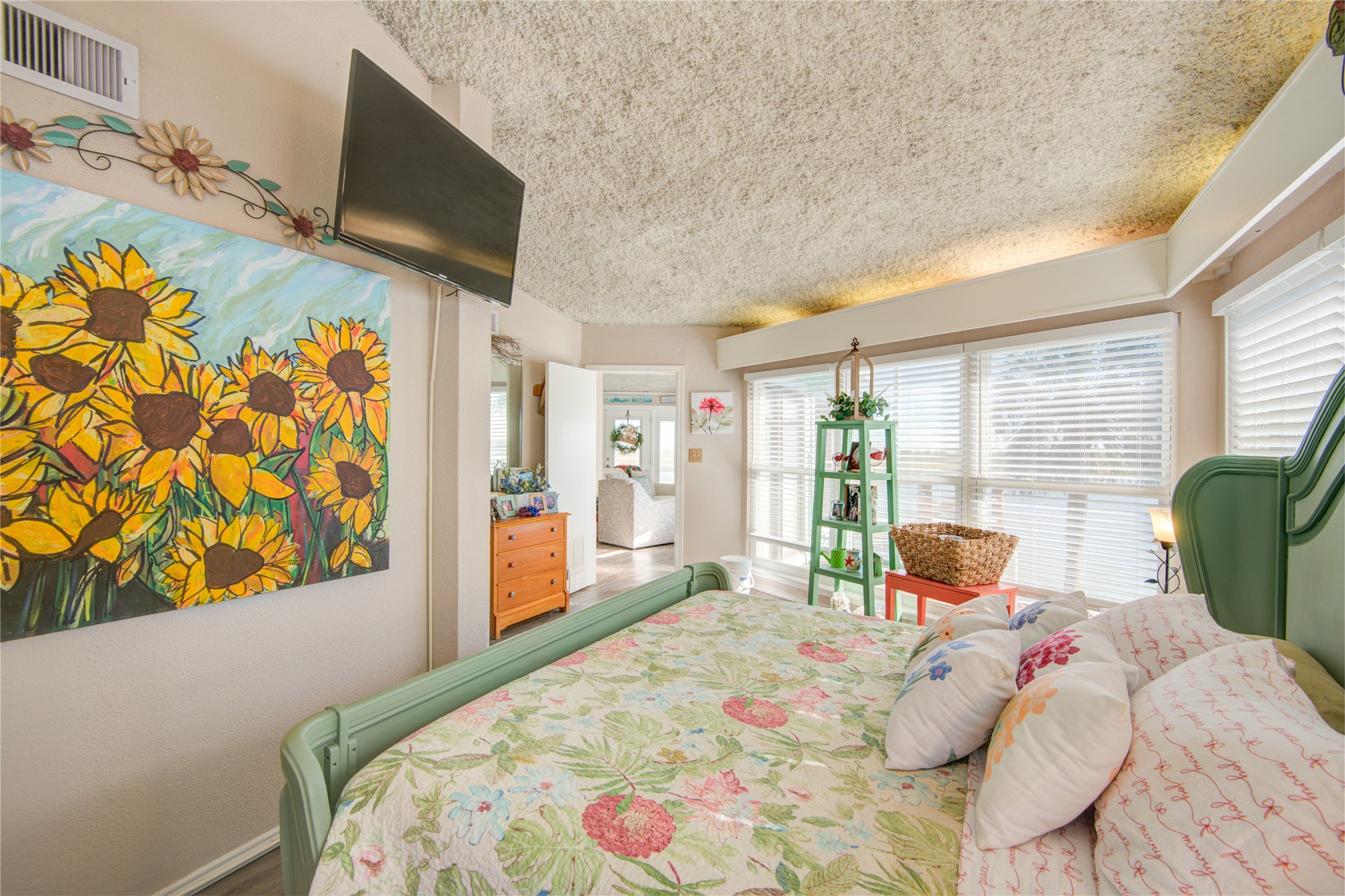 83 Dolphin Lane Freeport, TX 77541 - Photo 20 of 39 a bedroom with a bed window and flat screen tv