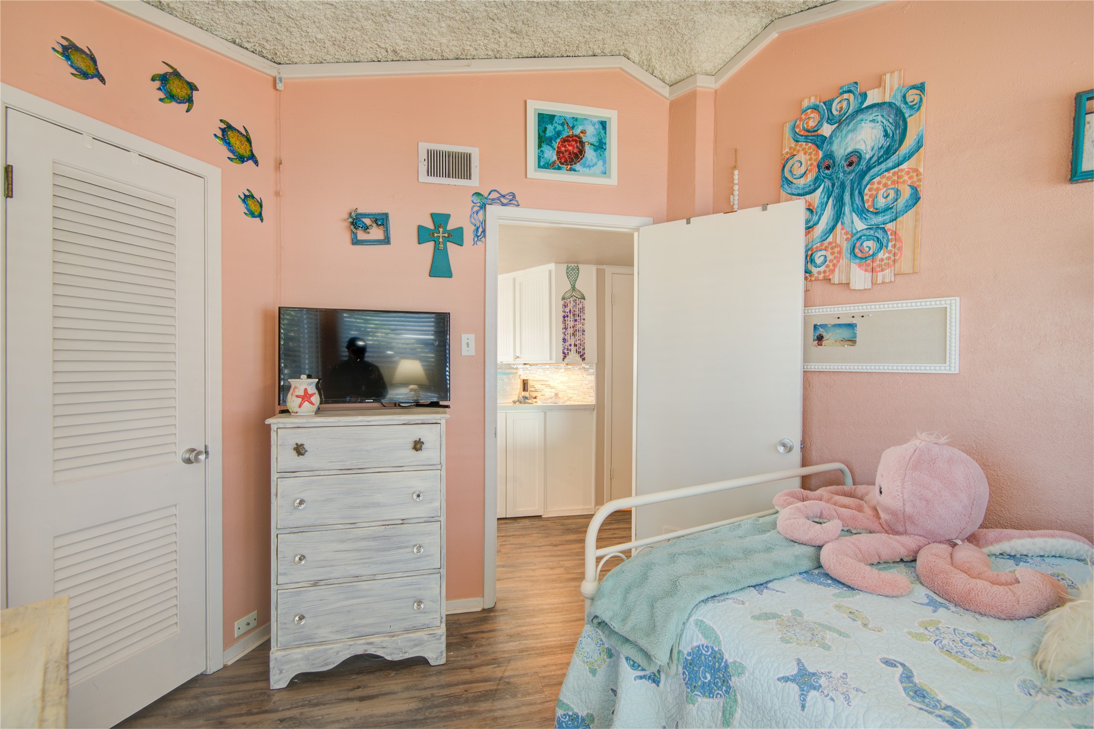 83 Dolphin Lane Freeport, TX 77541 - Photo 24 of 39 a bedroom with a bed and wooden floor