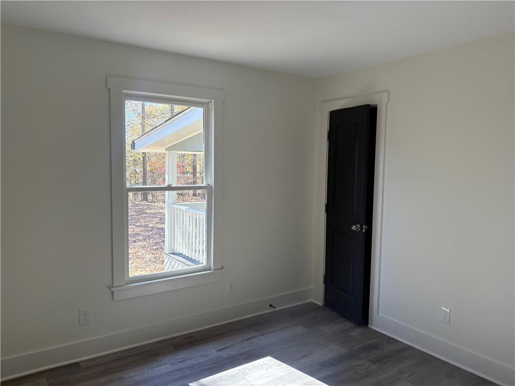 59 Woodhaven Path Rockmart, GA 30153 - Photo 11 of 17 an empty room with wooden floor and windows