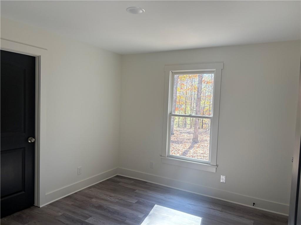 59 Woodhaven Path Rockmart, GA 30153 - Photo 14 of 17 an empty room with wooden floor and windows
