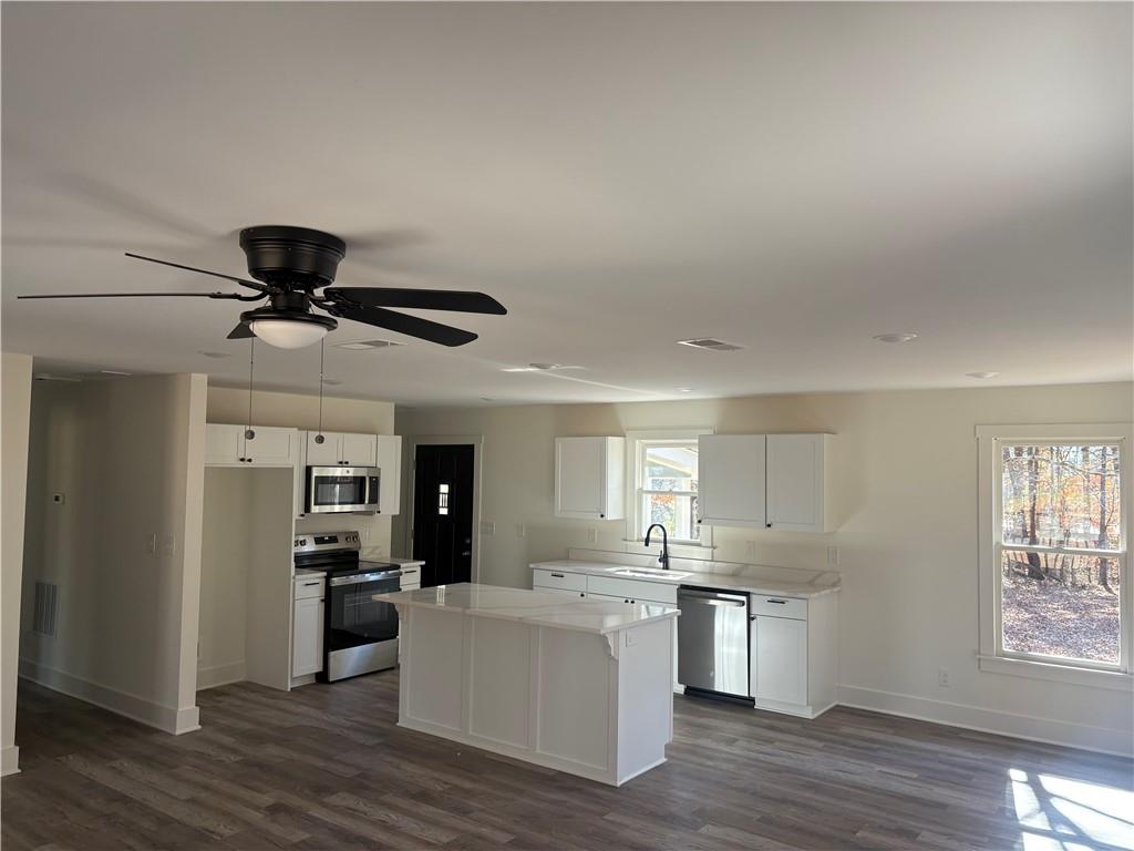 59 Woodhaven Path Rockmart, GA 30153 - Photo 3 of 17 a open kitchen with white cabinets and stainless steel appliances