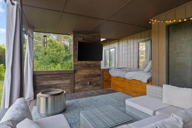 a living room with furniture and a potted plant