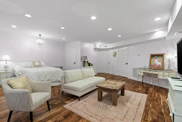 a bathroom with a toilet sink double vanity and mirror