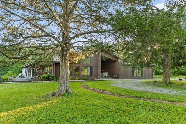 a front view of house with yard and green space