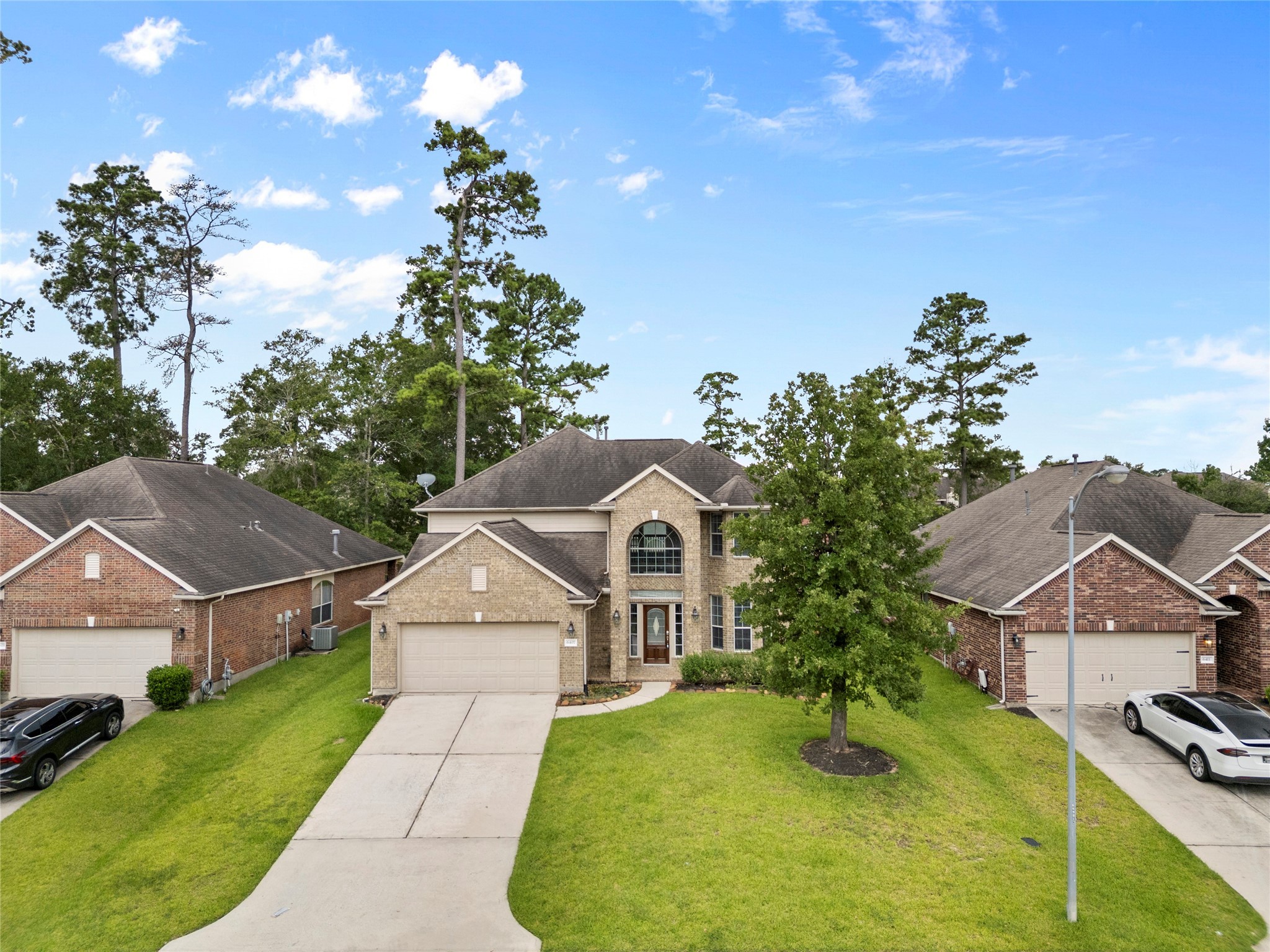 6407 Pine Rest Drive Spring, TX 77389 - Photo 2 of 26 a front view of a house with a yard and garage