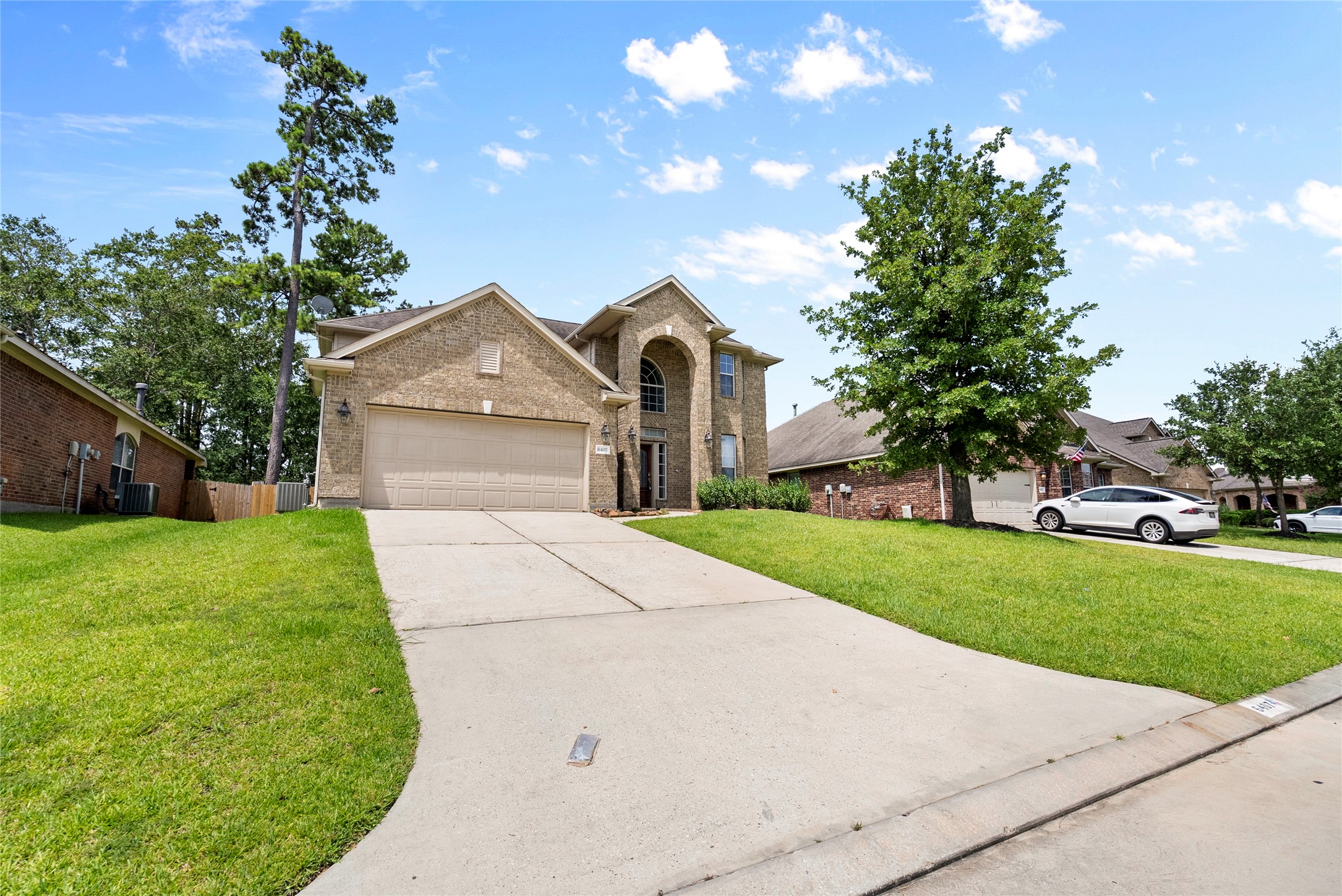 6407 Pine Rest Drive Spring, TX 77389 - Photo 4 of 26 a front view of a house with a garden and yard