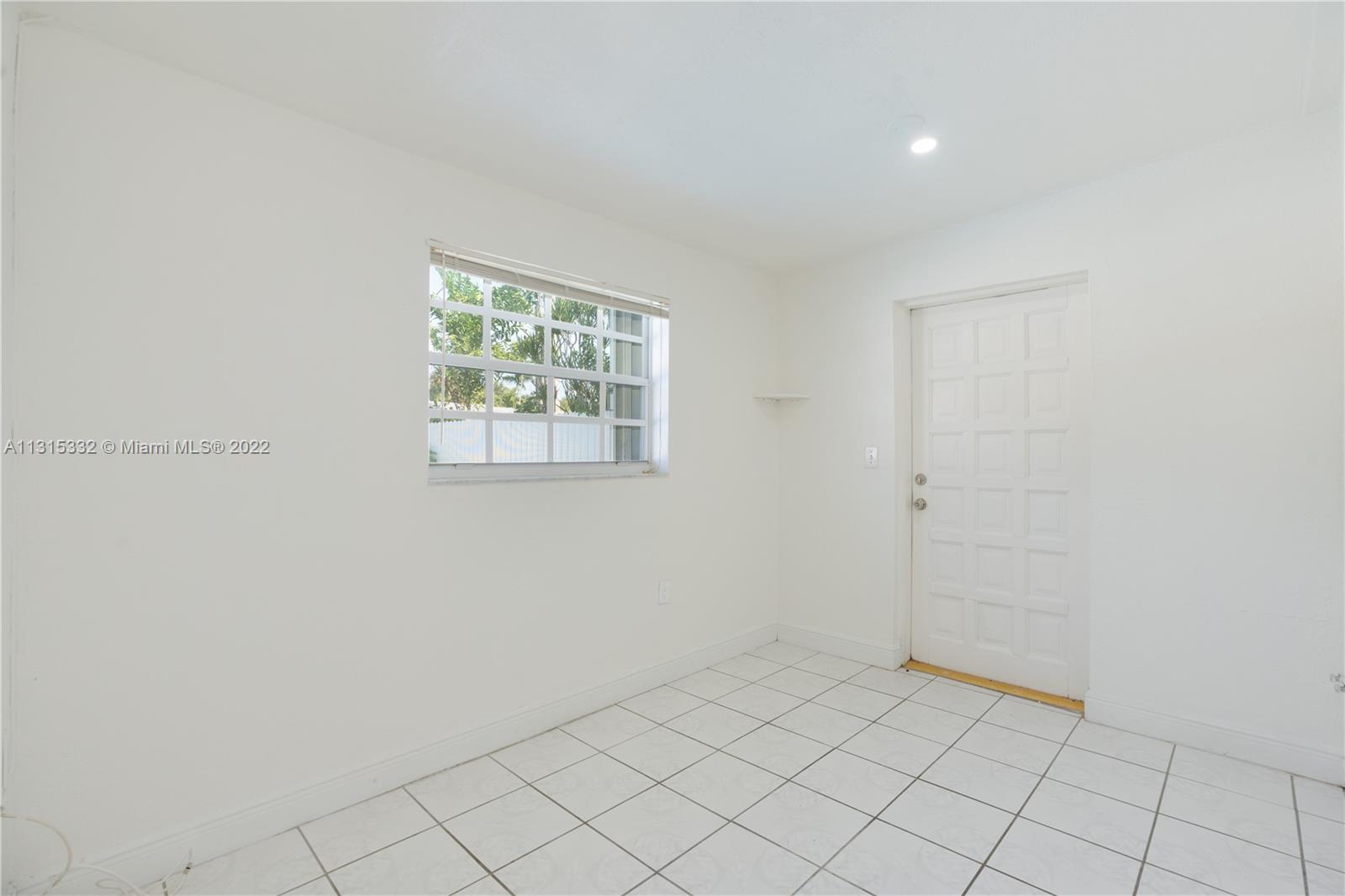 9215 Southwest 45th Street, Unit 9215 Miami, FL 33165 - Photo 12 of 37 an empty room with windows