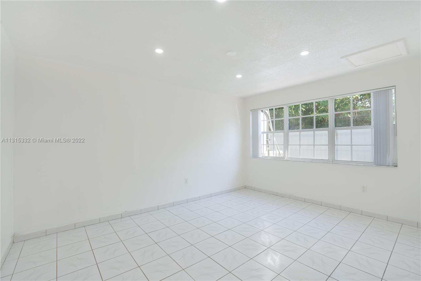 9215 Southwest 45th Street, Unit 9215 Miami, FL 33165 - Photo 13 of 37 an empty room with windows