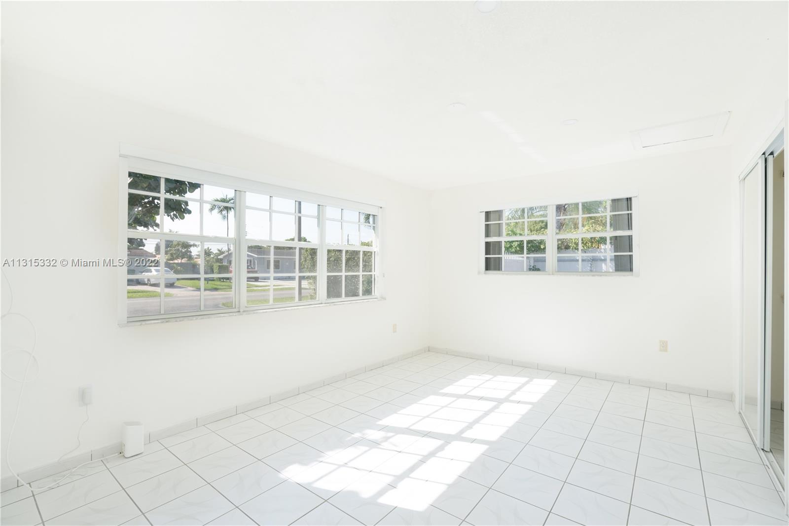 9215 Southwest 45th Street, Unit 9215 Miami, FL 33165 - Photo 14 of 37 an empty room with windows