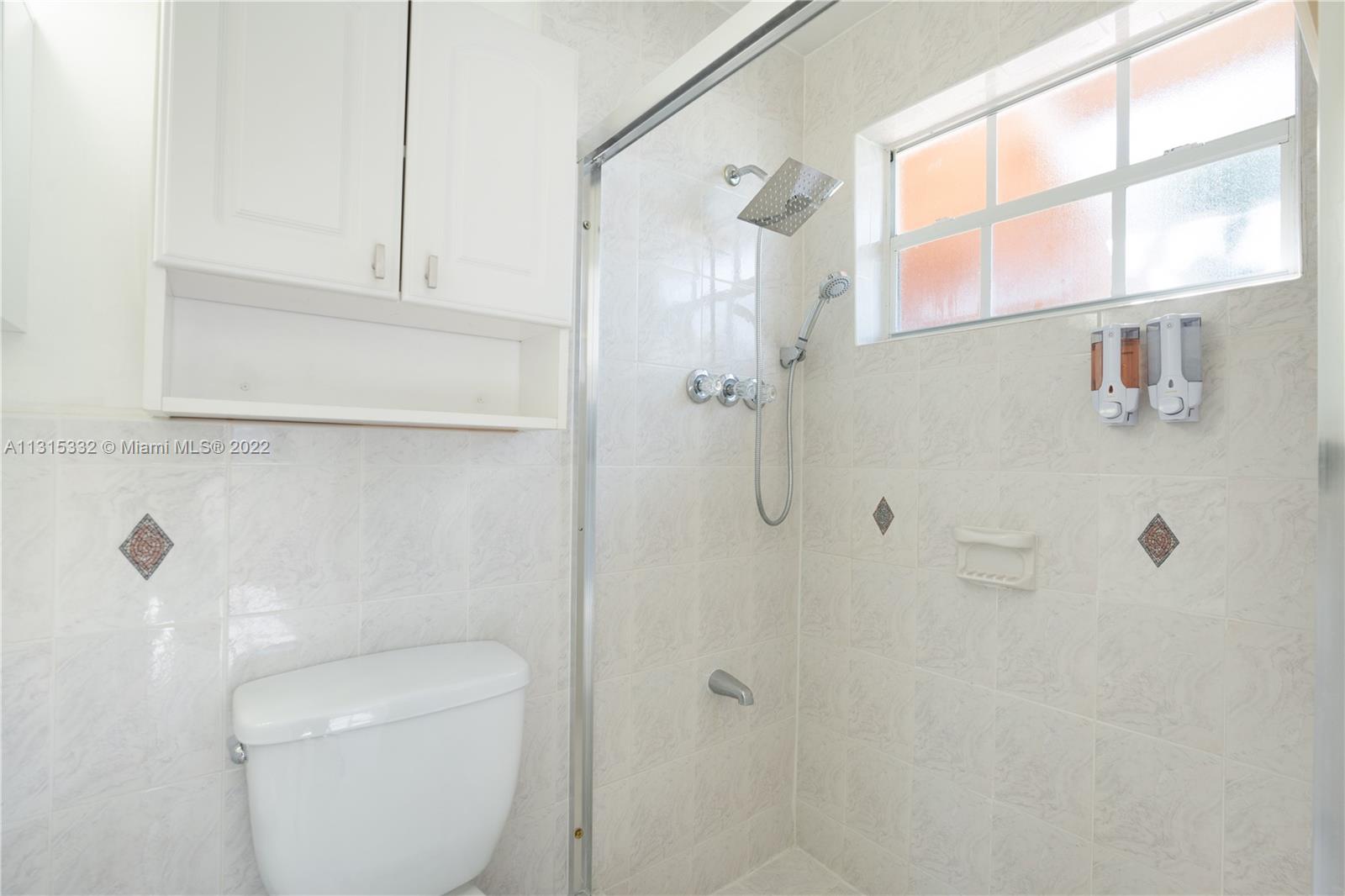 9215 Southwest 45th Street, Unit 9215 Miami, FL 33165 - Photo 18 of 37 a bathroom with a toilet and a shower