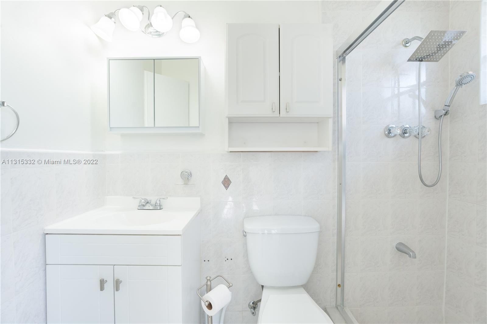 9215 Southwest 45th Street, Unit 9215 Miami, FL 33165 - Photo 19 of 37 a bathroom with a toilet sink and shower