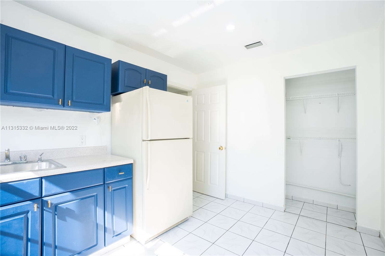 9215 Southwest 45th Street, Unit 9215 Miami, FL 33165 - Photo 20 of 37 a white refrigerator freezer sitting in a kitchen