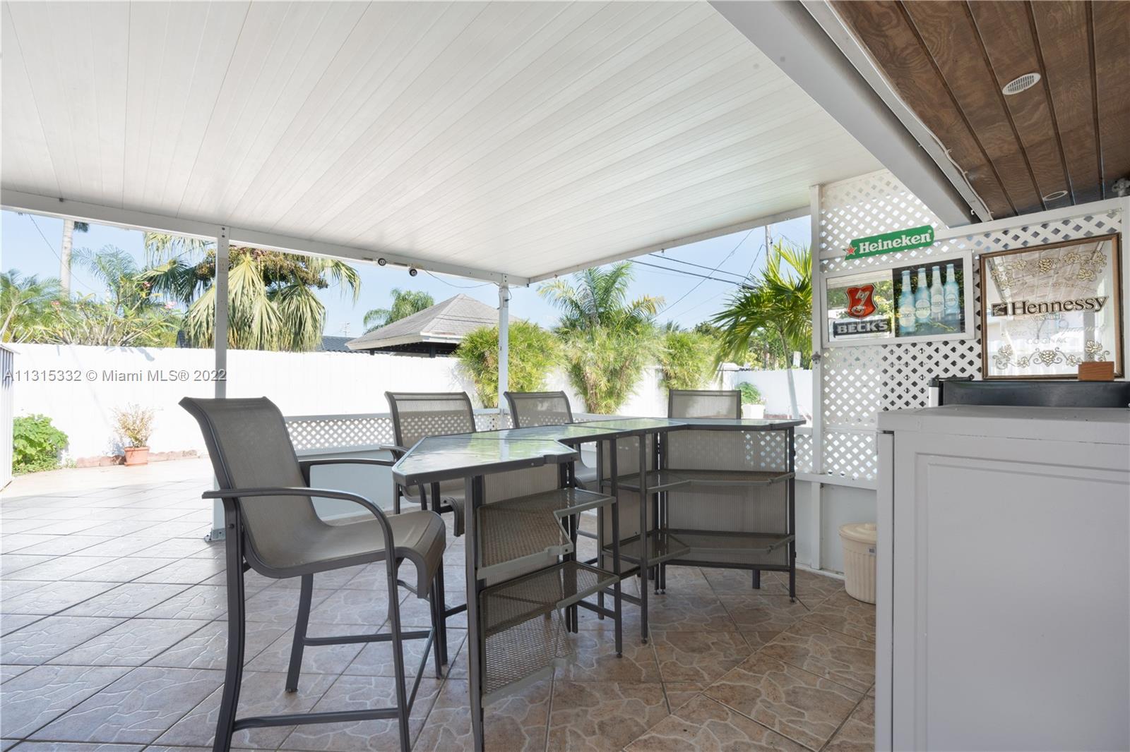9215 Southwest 45th Street, Unit 9215 Miami, FL 33165 - Photo 28 of 37 a dining room with furniture and a floor to ceiling window