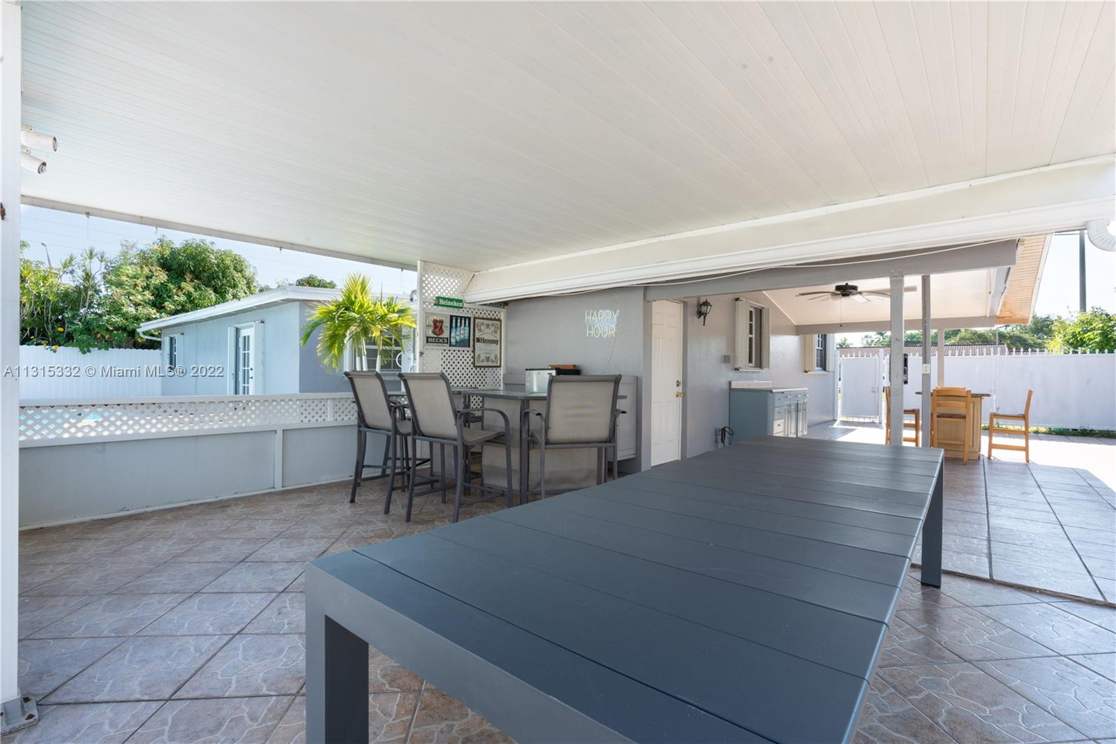 9215 Southwest 45th Street, Unit 9215 Miami, FL 33165 - Photo 29 of 37 a dining hall with stainless steel appliances a dining table and chairs with wooden floor