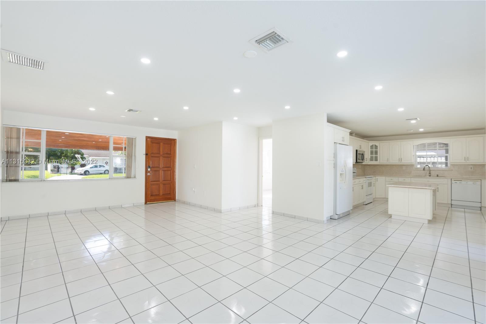 9215 Southwest 45th Street, Unit 9215 Miami, FL 33165 - Photo 3 of 37 a view of an empty room and window