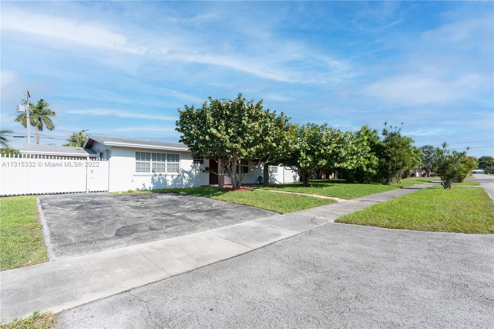 9215 Southwest 45th Street, Unit 9215 Miami, FL 33165 - Photo 37 of 37 a view of a house with a big yard and large tree