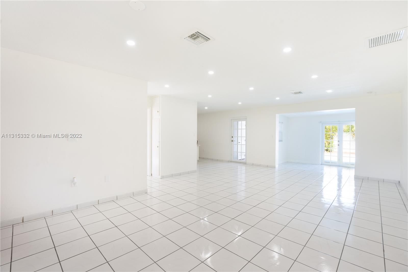9215 Southwest 45th Street, Unit 9215 Miami, FL 33165 - Photo 5 of 37 a view of an empty room and window