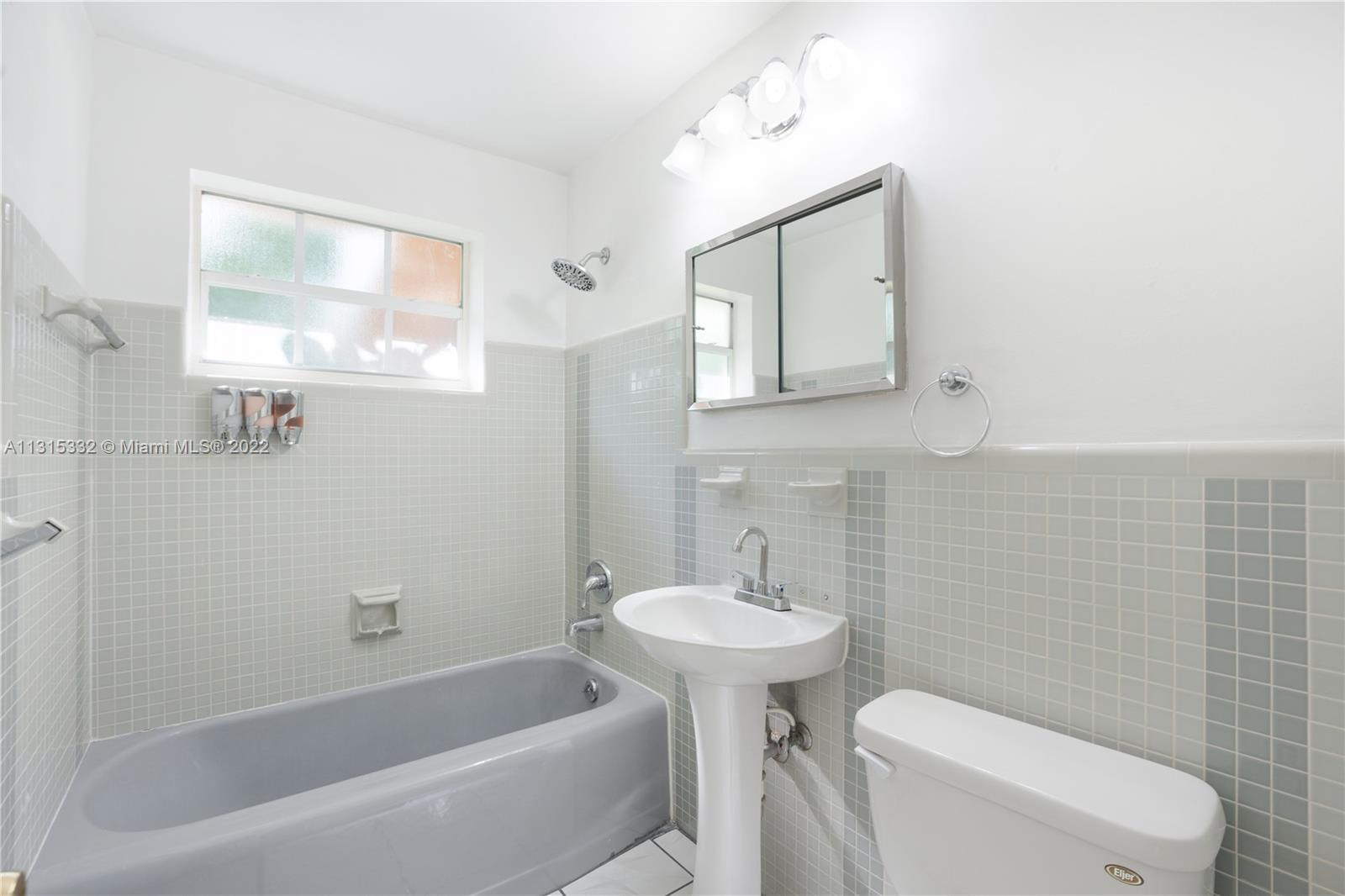 9215 Southwest 45th Street, Unit 9215 Miami, FL 33165 - Photo 9 of 37 a bathroom with a sink a toilet and bathtub