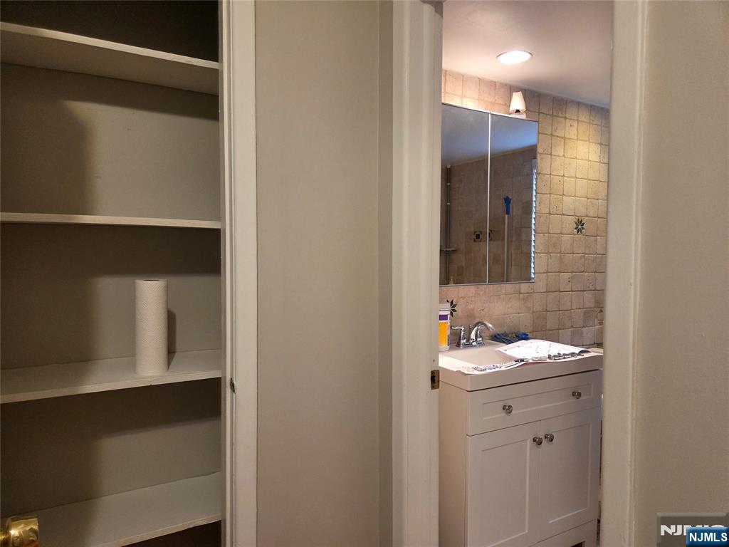 1315 Anderson Avenue, Unit 5 Fort Lee, NJ 07024 - Photo 11 of 16 a bathroom with a sink and a mirror
