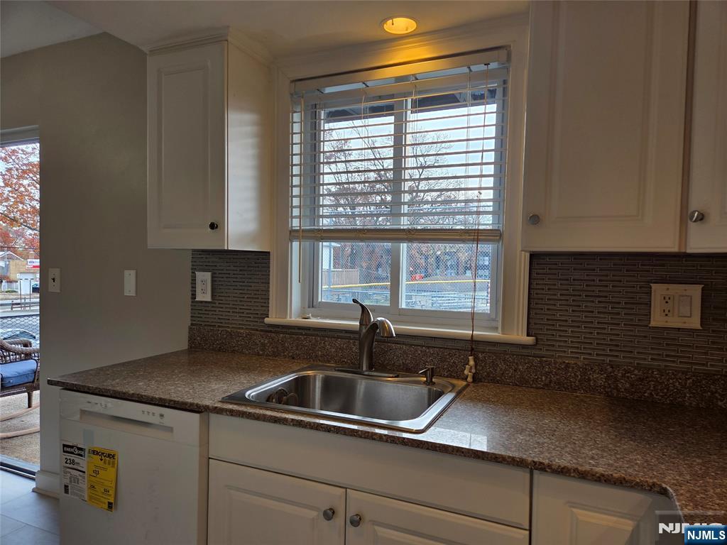 1315 Anderson Avenue, Unit 5 Fort Lee, NJ 07024 - Photo 3 of 16 a kitchen with granite countertop a sink and a window