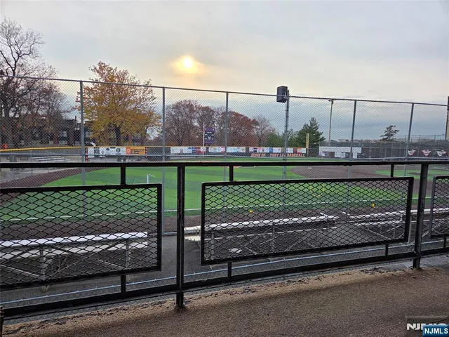 a view of a livingroom with wooden floor and a flat screen tv