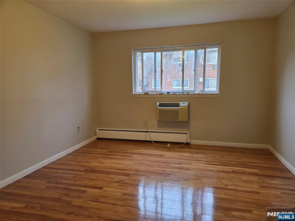 1315 Anderson Avenue, Unit 5 Fort Lee, NJ 07024 - Photo 9 of 16 a view of a room with wooden floor and window
