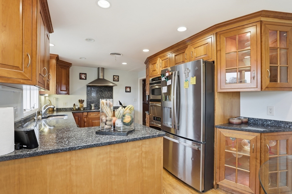 22 Burdett Road Lynn, MA 01904 - Photo 12 of 30 a kitchen with stainless steel appliances granite countertop a refrigerator a stove and a sink