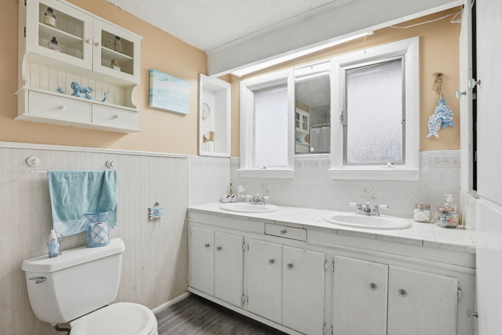 22 Burdett Road Lynn, MA 01904 - Photo 17 of 30 a bathroom with a toilet sink and mirror