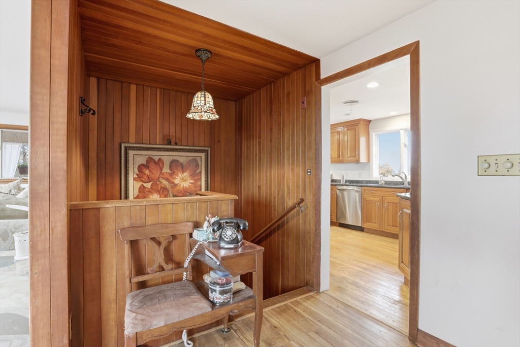 22 Burdett Road Lynn, MA 01904 - Photo 7 of 30 a view of a hallway with wooden floor and furniture