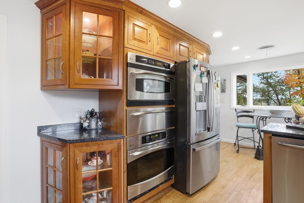 22 Burdett Road Lynn, MA 01904 - Photo 9 of 30 a kitchen with stainless steel appliances granite countertop a refrigerator and a stove top oven