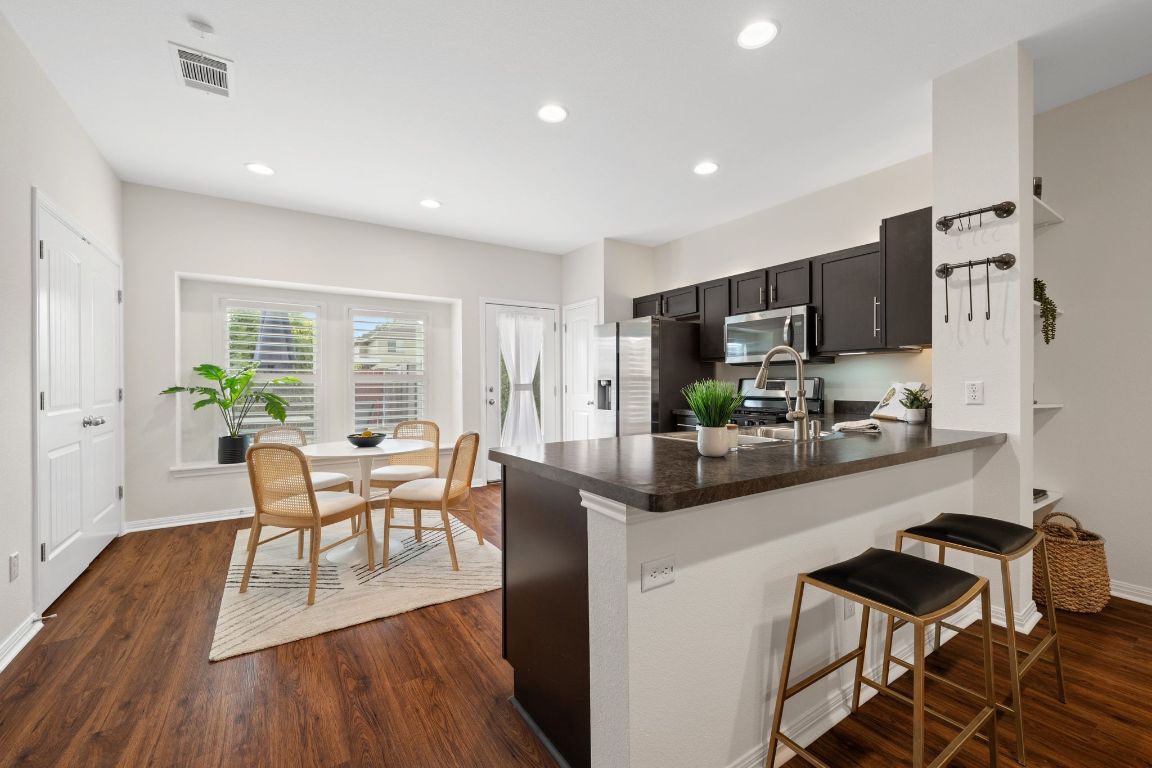 a view of a dining room with furniture and wooden floor