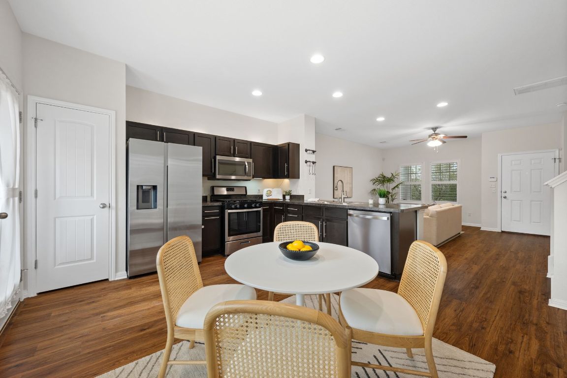 4517 Truth Way, Unit 412 Austin, TX 78725 - Photo 15 of 25 a view of a dining room with furniture and wooden floor
