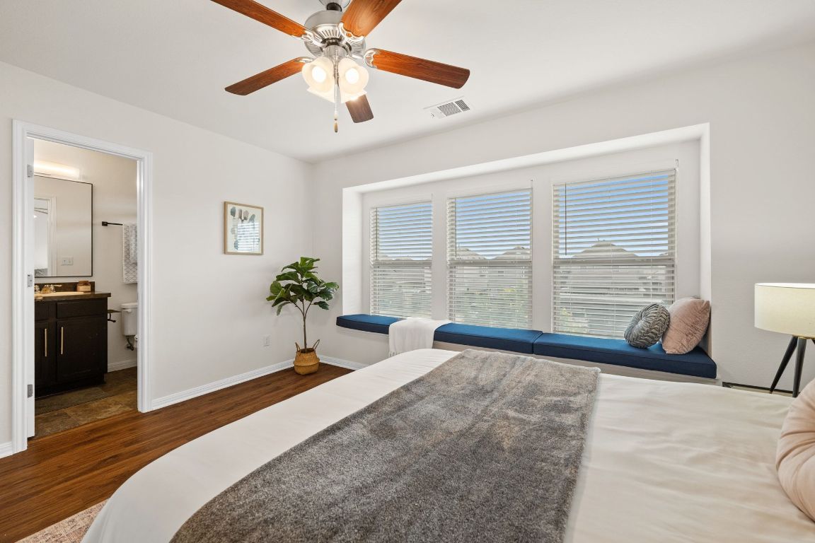 4517 Truth Way, Unit 412 Austin, TX 78725 - Photo 18 of 25 a bedroom with a bed and a large window