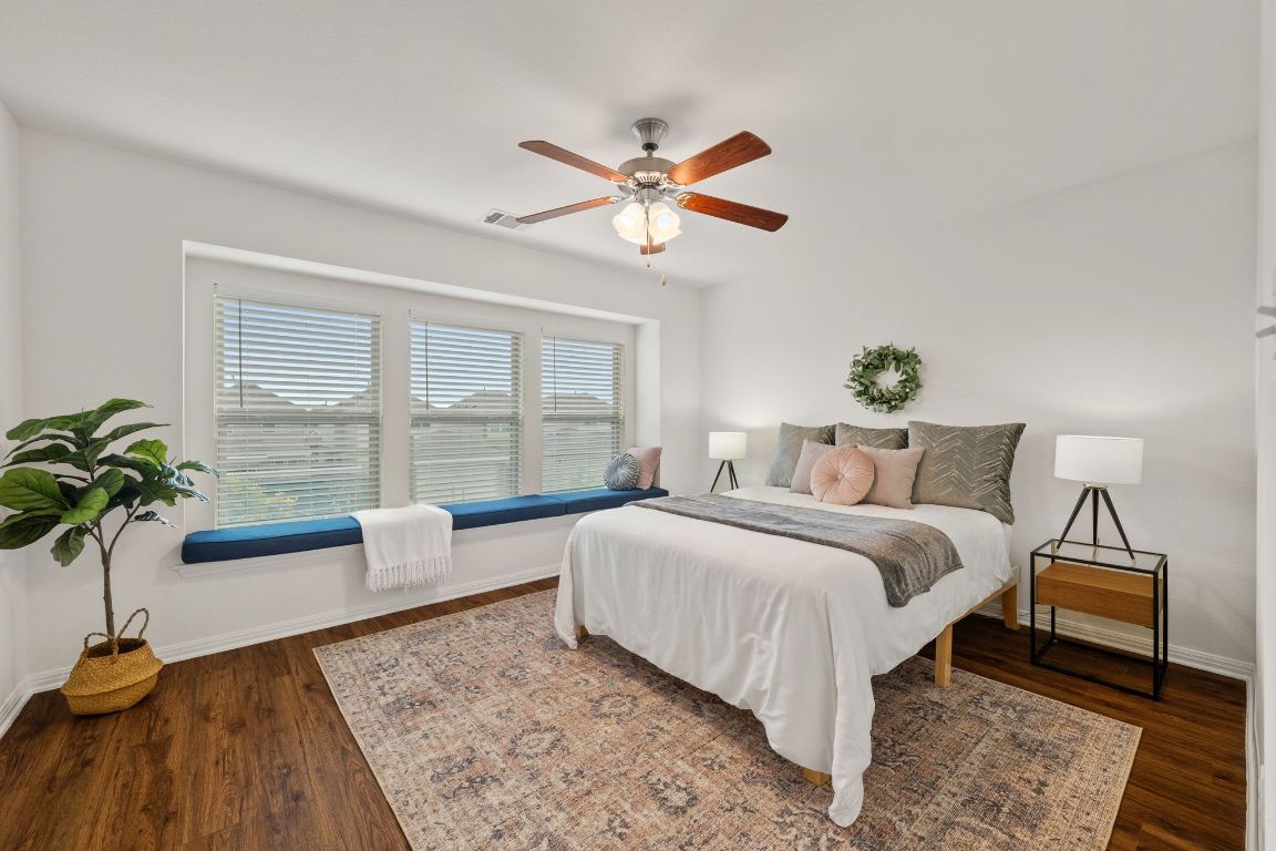 4517 Truth Way, Unit 412 Austin, TX 78725 - Photo 3 of 25 a bedroom with a bed and a chandelier