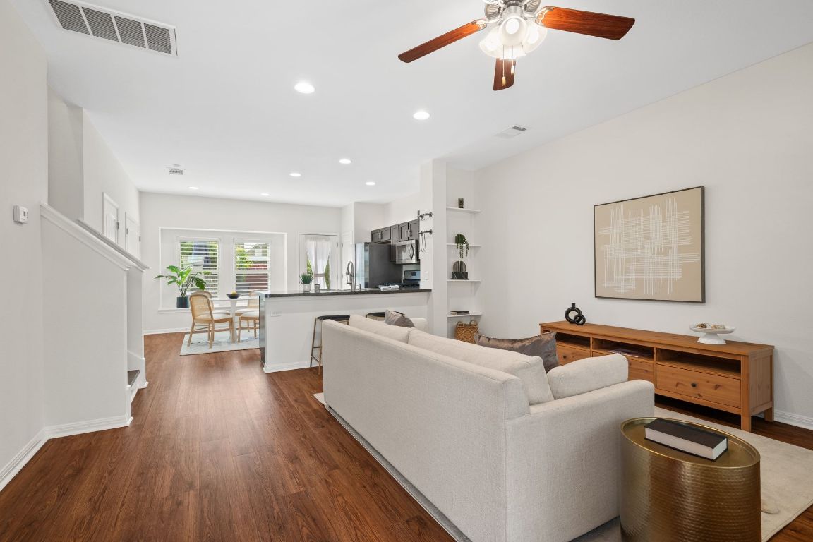4517 Truth Way, Unit 412 Austin, TX 78725 - Photo 4 of 25 a living room with furniture and a wooden floor