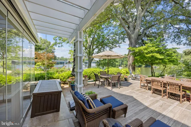 a view of backyard with outdoor seating and plants
