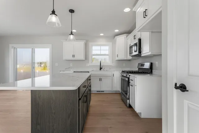 a kitchen with stainless steel appliances granite countertop a sink and a stove